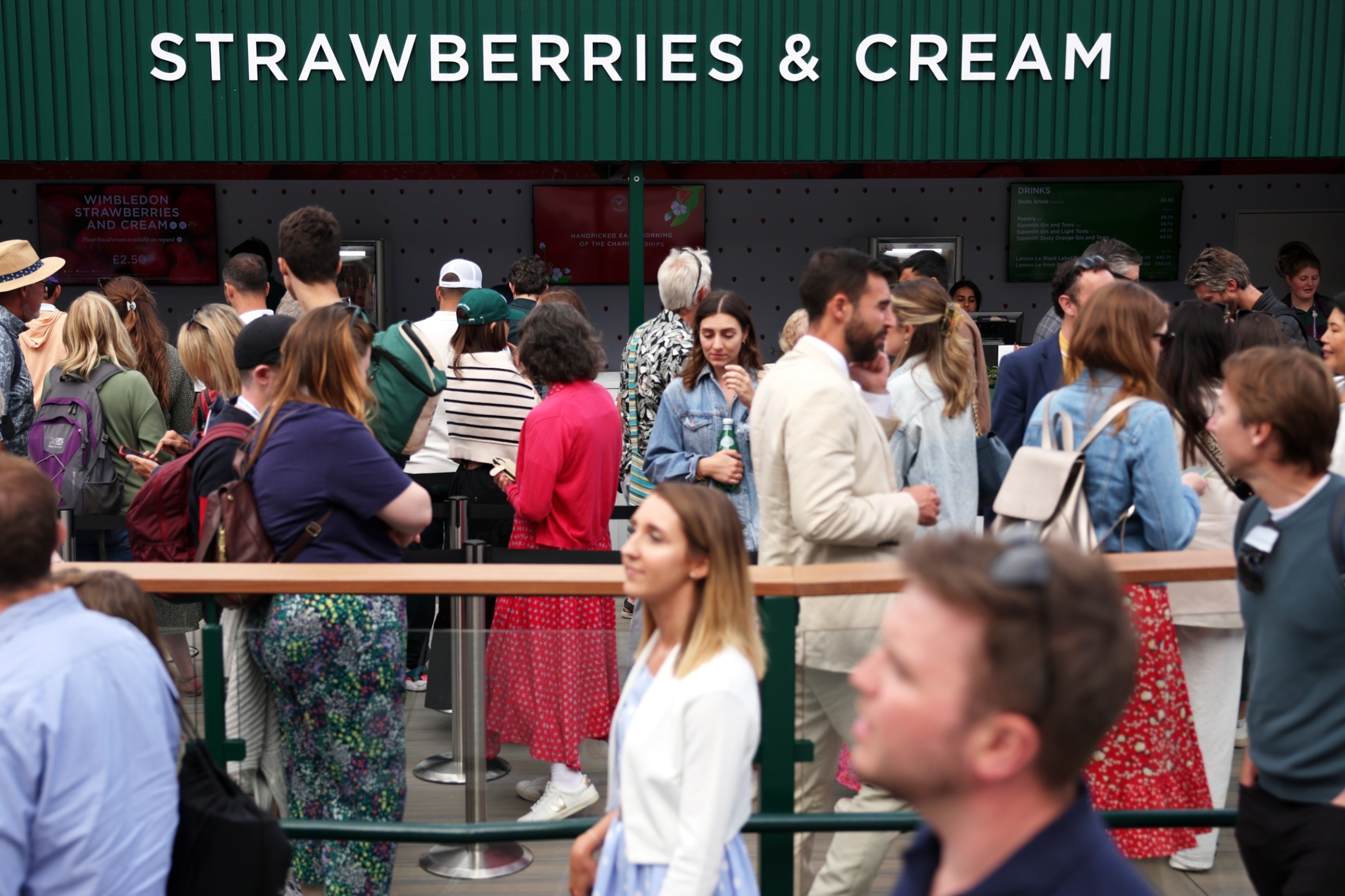 PHOTO: Spectators queue for a Strawberries and Cream vendor during day one of The Championships Wimbledon 2023 at All England Lawn Tennis and Croquet Club on July 3, 2023 in London.